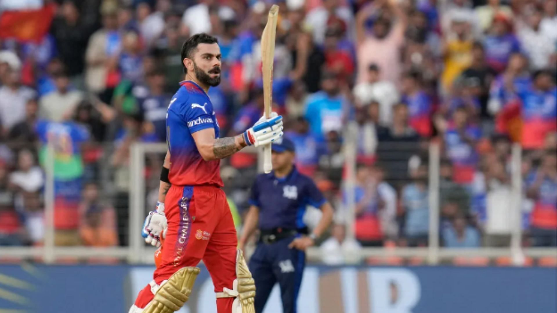 Kohli raises his bat after scoring a fifty against GT.